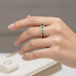 Model wearing gold 3mm princess cut rainbow channel-set eternity band ring on hand   