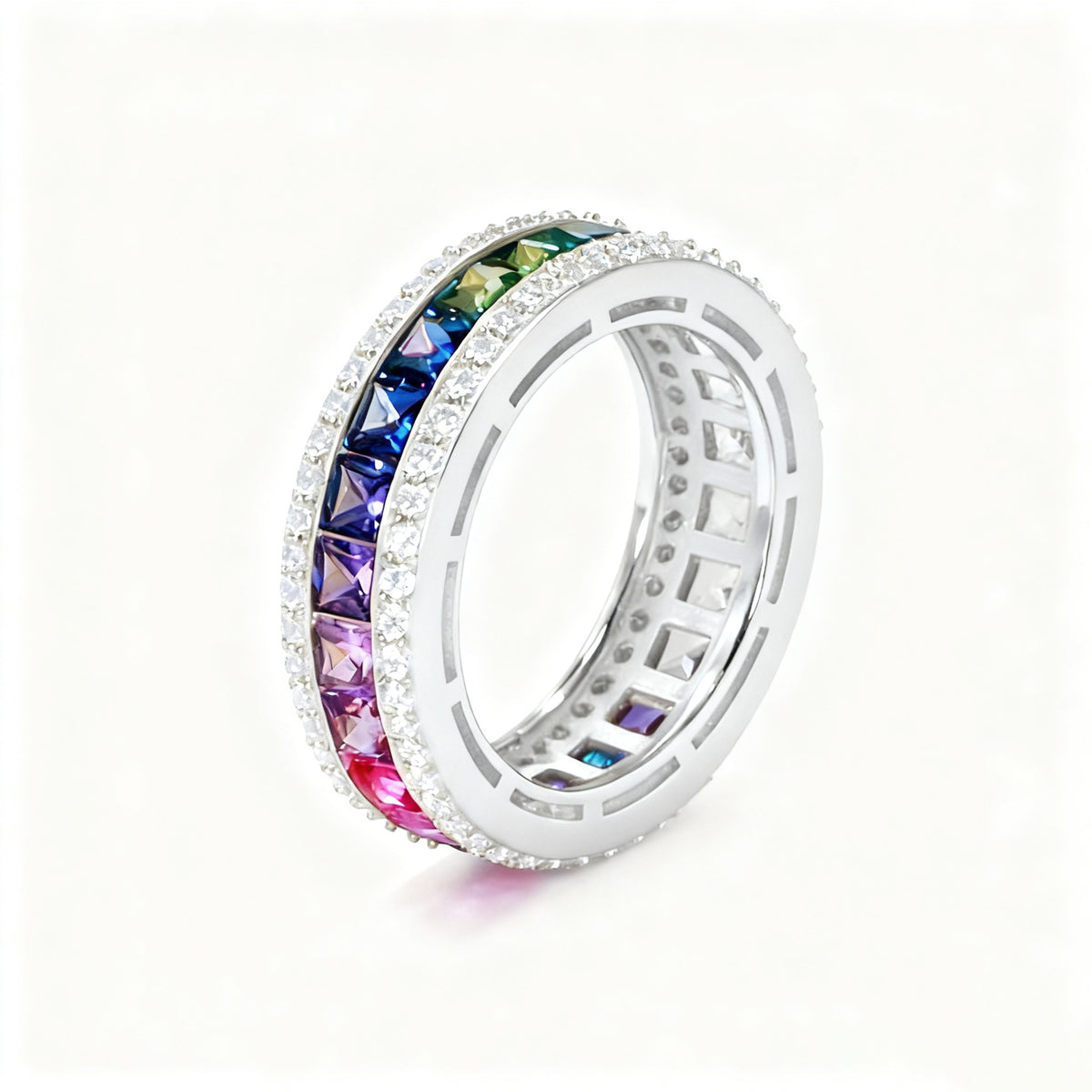 Silver 3mm princess cut rainbow channel-set eternity band ring with pave borders on white studio background