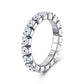 Side profile view of 3mm round cut moissanite shared prong eternity ring.