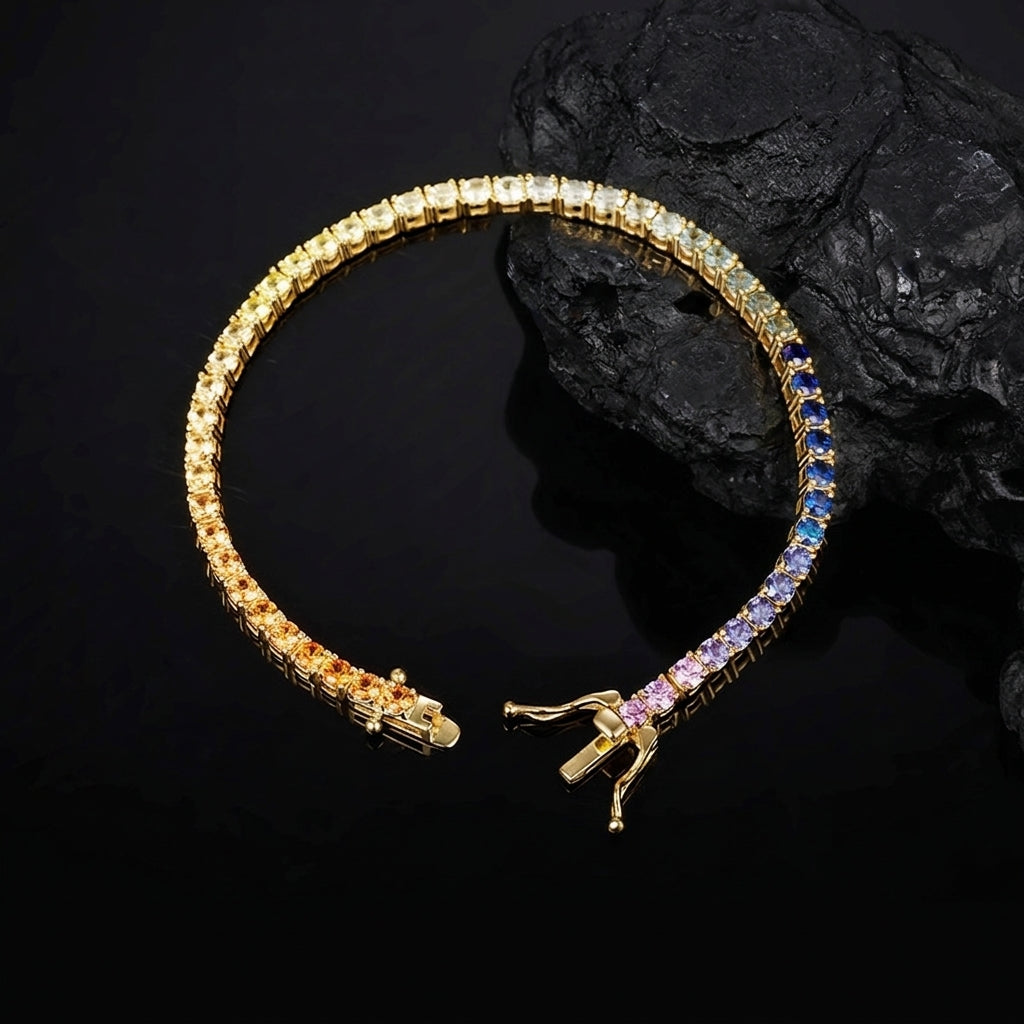 Gold 3mm round rainbow gradient moissanite tennis bracelet with double safety box clasp on dark stone surface