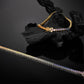 Gold and silver 3mm round rainbow gradient moissanite tennis bracelets displayed on dark textured background   