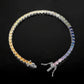 Silver 3mm round rainbow gradient moissanite tennis bracelet unclasped on dark background
