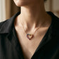 Model wearing gold 3mm round rainbow gradient open heart pendant necklace on neck