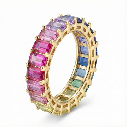 Gold 3x5mm emerald cut rainbow eternity band ring with multi-color gemstones isolated on white studio background   