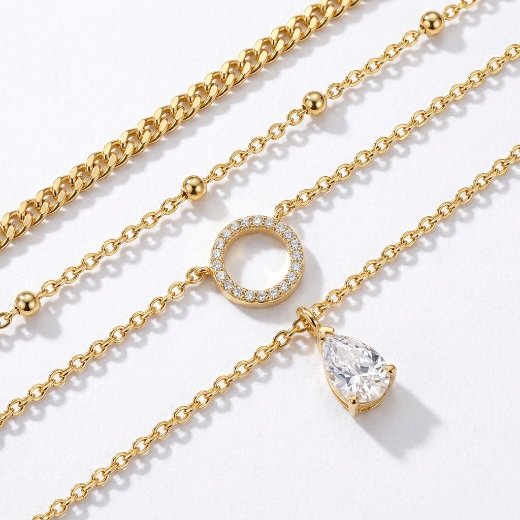 Macro, layered necklaces in 45° diagonal parallel layout, even spacing, mirror-polished gold, bright clean lighting, sharp stone brilliance, white textured background, soft shadow, ultra-detailed.