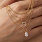 Macro, necklace draped across female hand, natural curve, warm soft light, mirror metal shine, sharp sparkle, blurred skin background, detailed texture, intimate luxury feel.