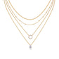 Clean white background — four chains layered elegantly on a bust form, each with its own moissanite pendant or accent. The different chain lengths (14", 16", 18", 20") create a dramatic cascading effect. Moissanite stones catch light from multiple angles, showcasing brilliant sparkle across all four layers.