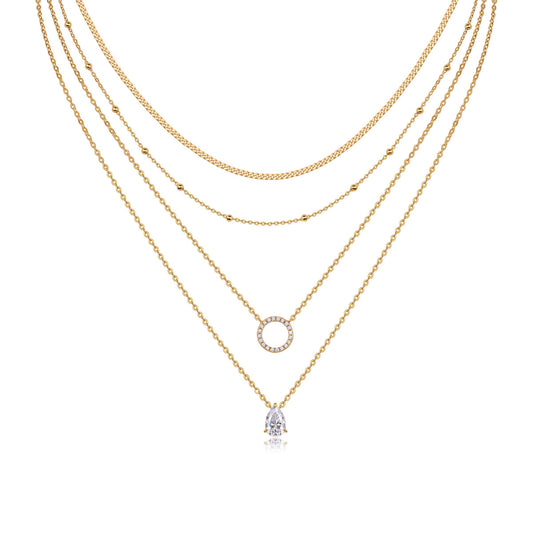 Clean white background — four chains layered elegantly on a bust form, each with its own moissanite pendant or accent. The different chain lengths (14", 16", 18", 20") create a dramatic cascading effect. Moissanite stones catch light from multiple angles, showcasing brilliant sparkle across all four layers.