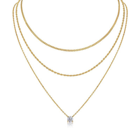 Clean white background — the 4-prong round moissanite pendant layered with 2-3 mixed chains on a bust form. The solitaire catches soft light, showcasing the round brilliant cut’s sparkle with minimal metal interference. Chains vary in texture for subtle visual interest.