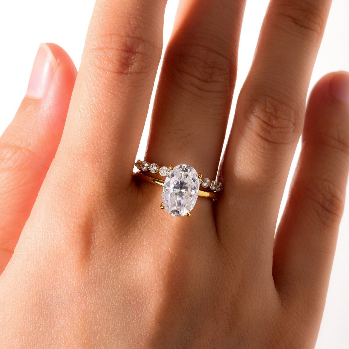 Set worn as double-stacked wedding rings. Alt: “Luxury Statement: Oval Diamond Bridal Set.”