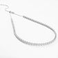 Include a second image showing the necklace gently curved to reveal flexibility and light reflection across multiple flower links.