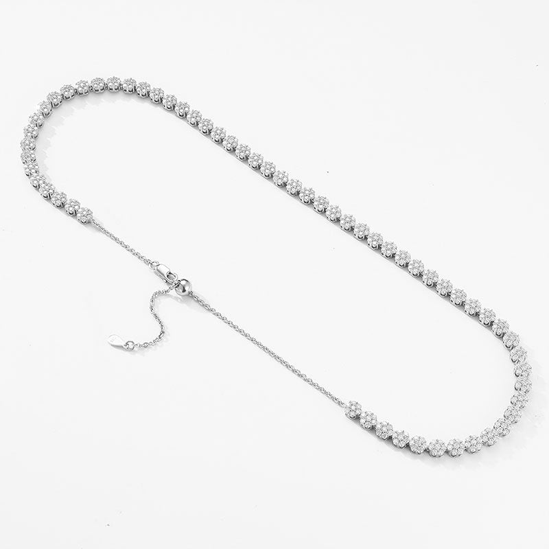 Straight-on to clearly showcase the continuous floral motif chain—each flower link and its pavé moissanite coverage.