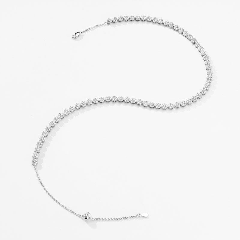 Include a second image showing the necklace gently curved to reveal flexibility and light reflection across multiple flower links.