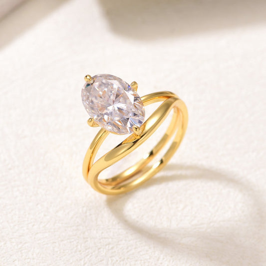 Gold engagement set on neutral/romantic background. Alt: “4.5ct Oval Moissanite Engagement Ring Set – Gold.”