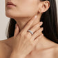 Model holding hand near neck showing 4ctw round diamond micro-pave halo eternity band.