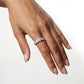Model wearing 4ctw round diamond micro-pave halo eternity band ring on finger.