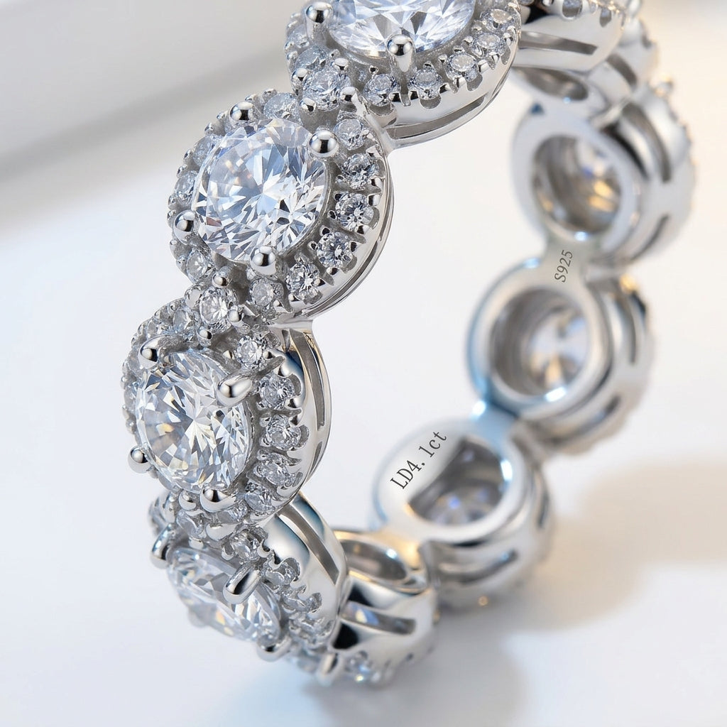 A close-up of a silver-toned diamond bracelet featuring oval-cut center stones surrounded by halo and round accent diamonds, photographed on a clean white background.