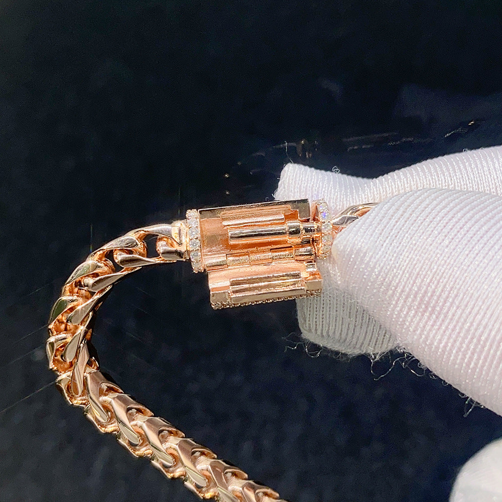 Gloved hand demonstrating open clasp mechanism on 4mm rose gold franco chain necklace with moissanite clasp