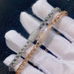 Gloved hand holding silver and rose gold 4mm franco chain necklaces with iced out moissanite box clasps