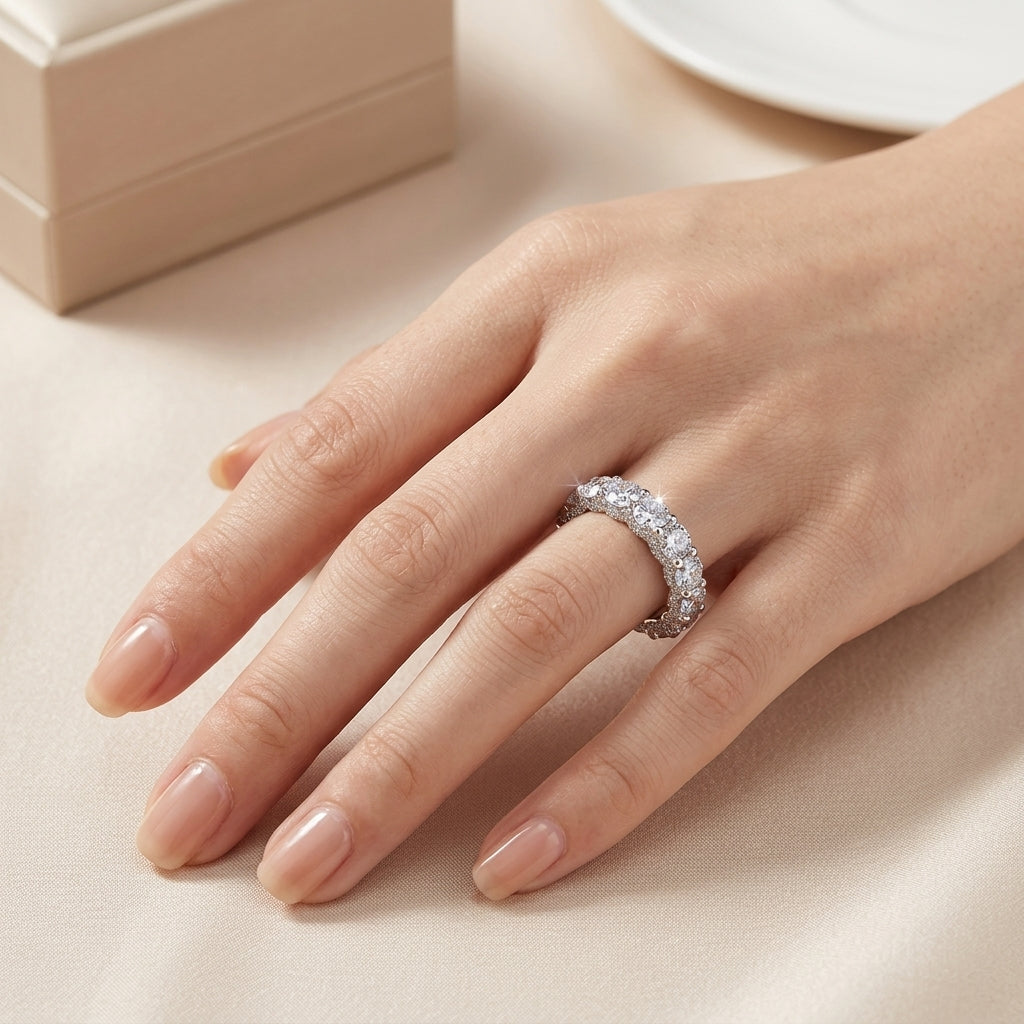 Full hand shot of model wearing 5.17ctw round cut side pave eternity ring.
