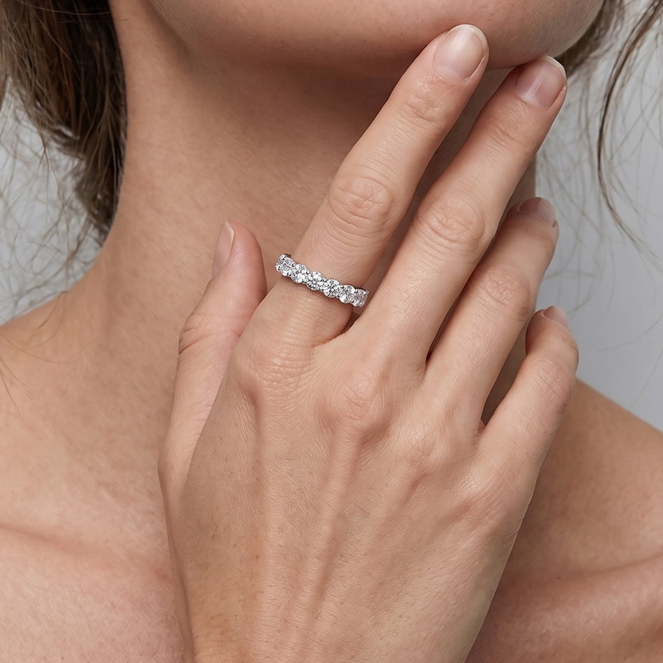 Model wearing 5.17ctw round cut side pave diamond simulant eternity ring.