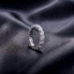 5.17ctw round cut diamond simulant eternity ring standing upright on dark silk.