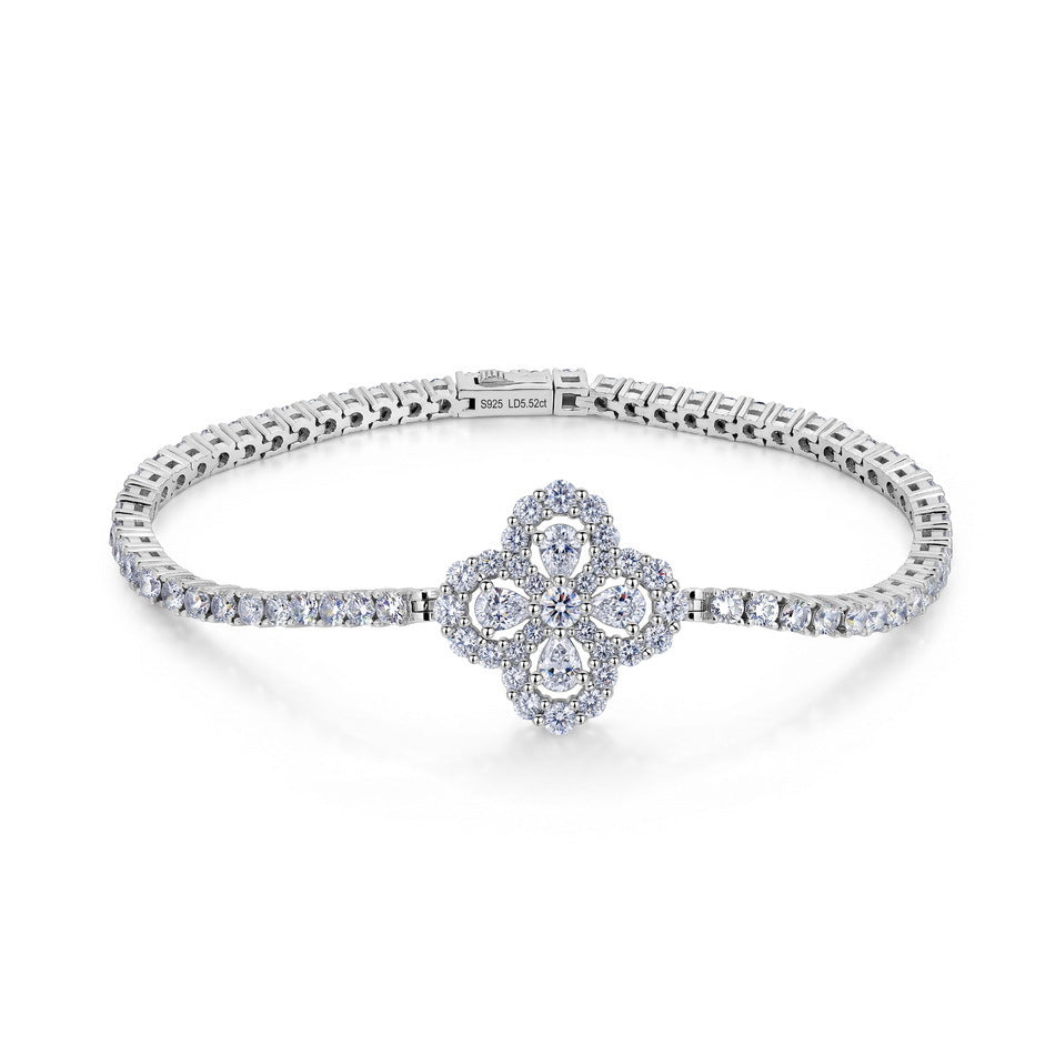 5.52 CTW diamond quatrefoil flower tennis bracelet in sterling silver.