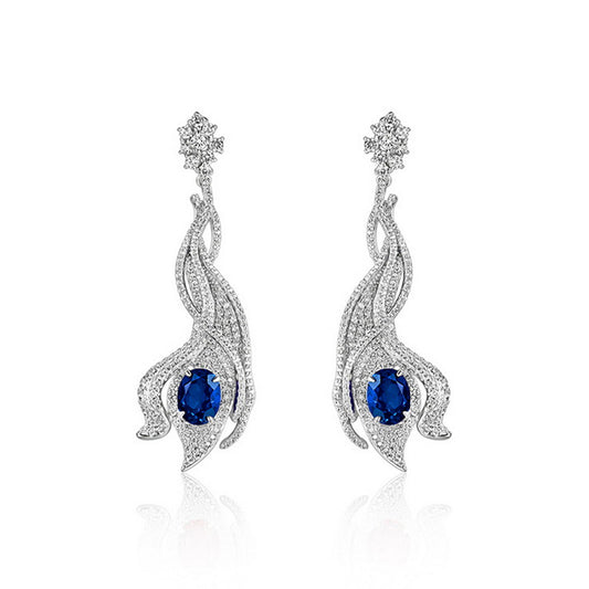 Luxury 5ct oval-cut royal blue sapphire wave earrings, sterling silver halo setting.
