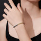 Model wearing gold 5mm oval cut rainbow gradient moissanite classic tennis chain bracelet on wrist