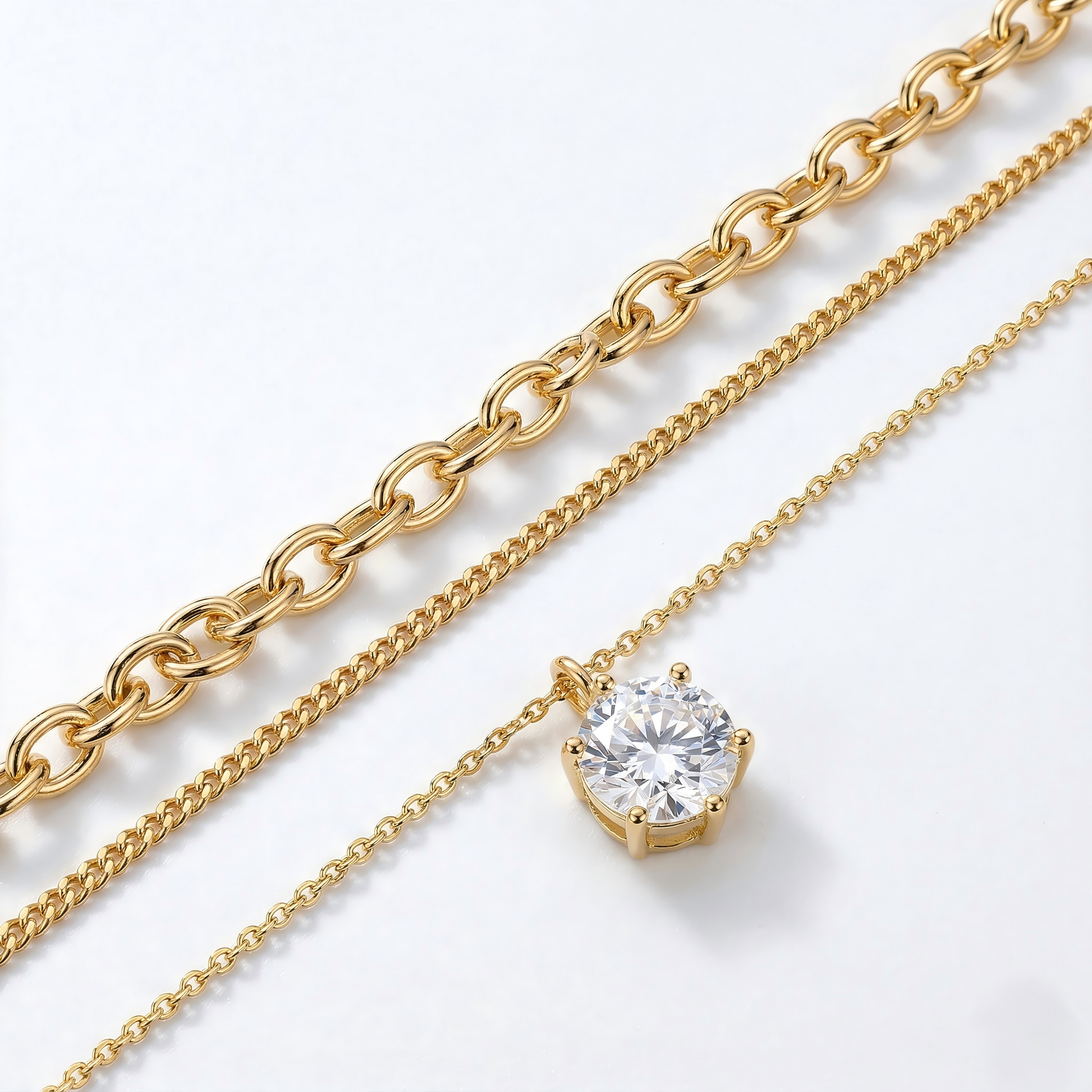 Two gold chains with one featuring a diamond pendant on a white background