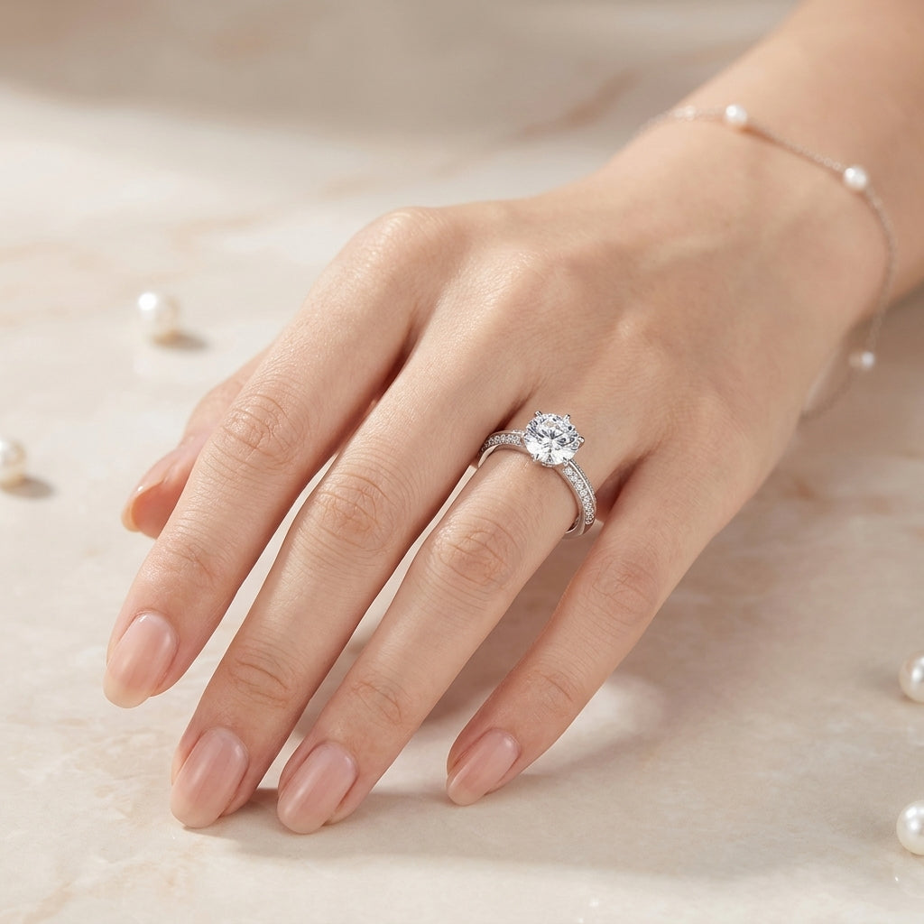 Close-up view of a woman's hand showcasing the sparkling 6-prong round cut moissanite solitaire ring.