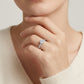 Model wearing the classic 6-prong round moissanite engagement ring with micro-pavé band.