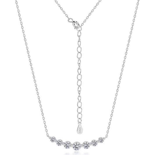 7-stone graduated lab diamond curved bar smile necklace in 925 sterling silver.