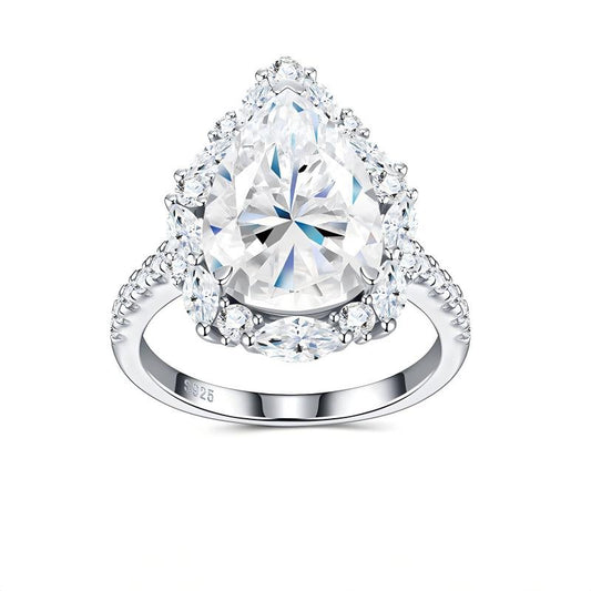 8CT pear cut moissanite engagement ring with starburst marquise cluster halo and pave shank on white background.