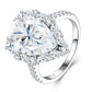 Angled close-up view showing prong setting and starburst marquise halo on 8CT pear moissanite ring.