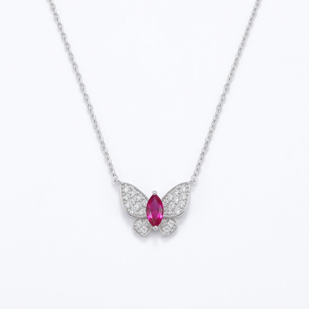 White background front view of a 925 sterling silver marquise ruby butterfly necklace on a delicate fine cable chain.