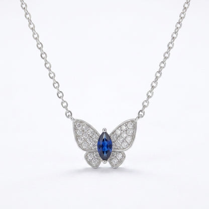 White background front view of a 925 sterling silver marquise sapphire butterfly necklace on a fine cable chain.