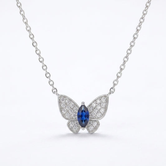 White background front view of a 925 sterling silver marquise sapphire butterfly necklace on a fine cable chain.