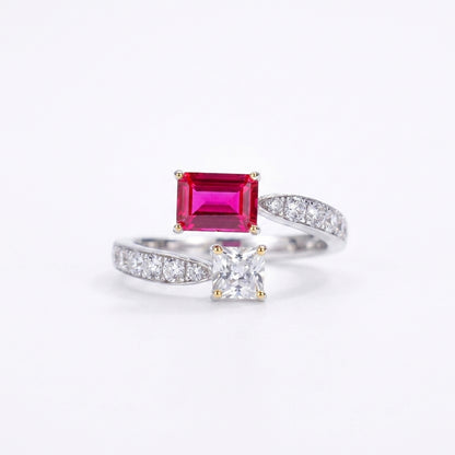 White background front shot of a 925 sterling silver two-stone engagement ring featuring an emerald-cut lab ruby and a princess-cut gem.