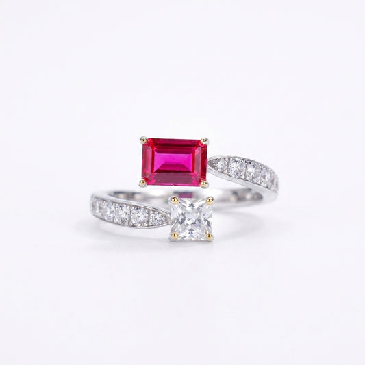 White background front shot of a 925 sterling silver two-stone engagement ring featuring an emerald-cut lab ruby and a princess-cut gem.