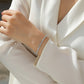 Bracelet styled with evening or bridal attire. Alt: “Warm Elegance: Styling Gold Moissanite Bracelet.”