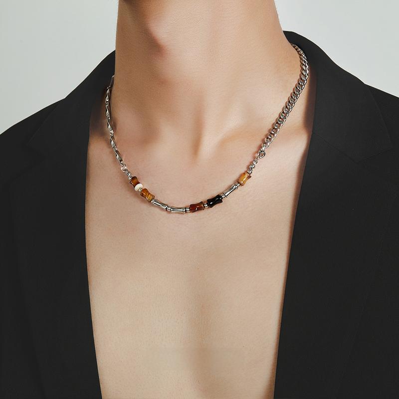 “Side view of vintage-inspired silver bamboo necklace with gemstone detail”