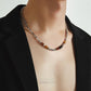 “Side view of vintage-inspired silver bamboo necklace with gemstone detail”