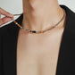 “Side view of vintage-inspired silver bamboo necklace with gemstone detail”