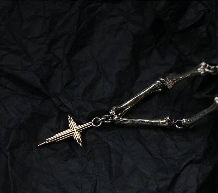 “Close-up of handcrafted bone-style cross pendant in solid 925 silver”