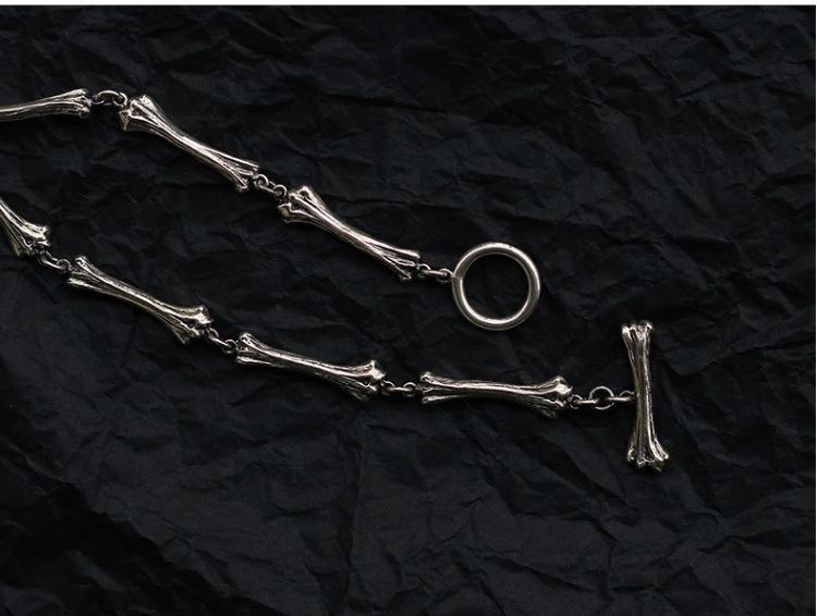 “Close-up of handcrafted bone-style cross pendant in solid 925 silver”