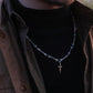“Male model wearing gothic silver bone cross pendant necklace”