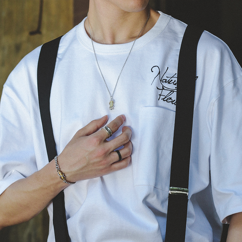 “Unisex silver bullet pendant necklace styled with streetwear outfit”