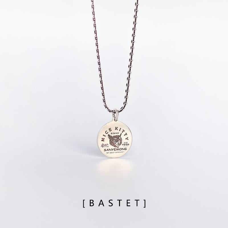 “Sterling silver minimalist cat tag necklace flat lay”