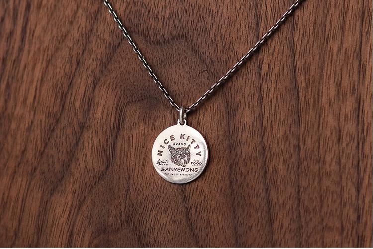 “Engraving detail on sterling silver cat tag pendant custom jewelry”